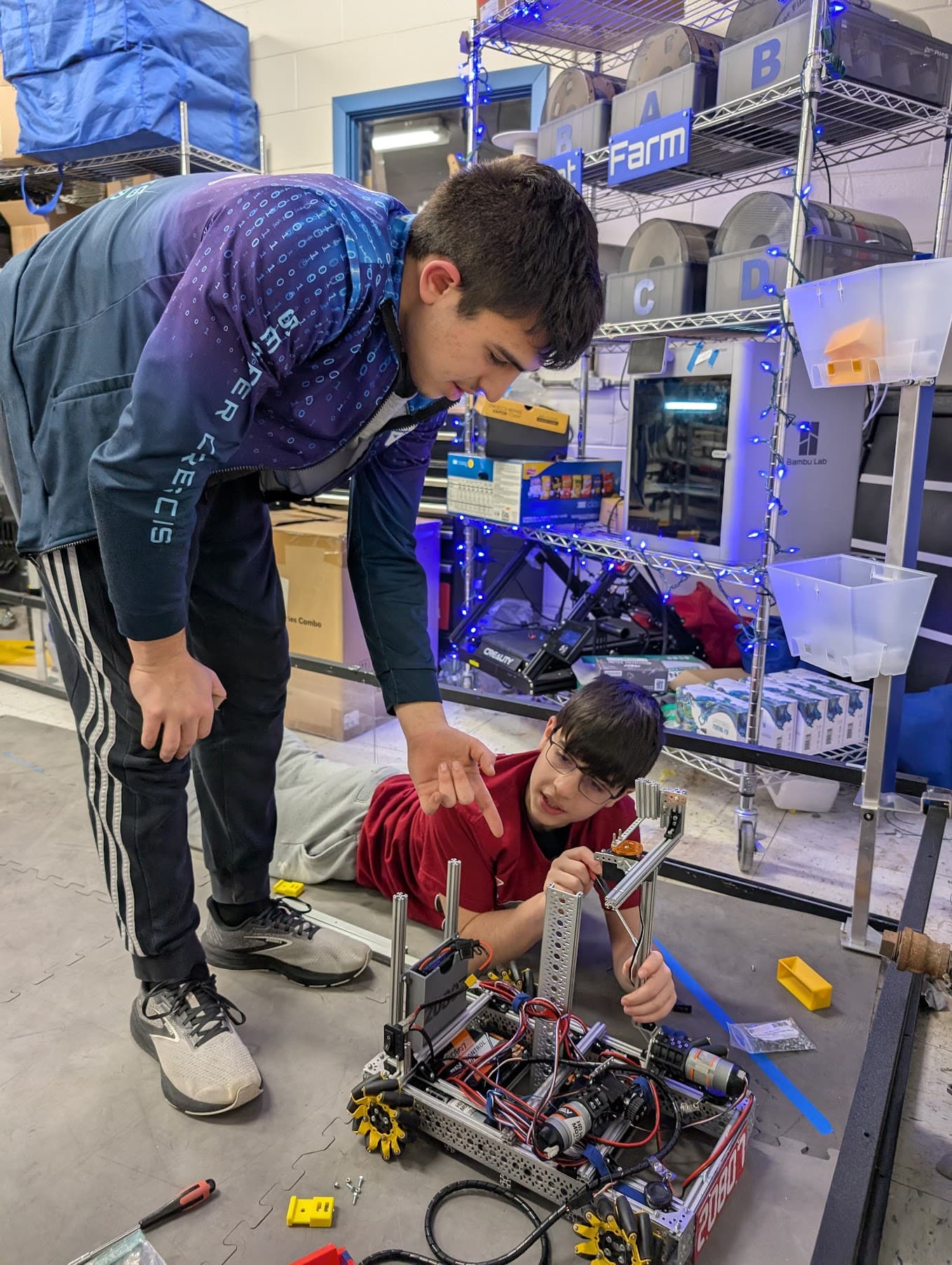 Joey helping phoenix with their robot.
