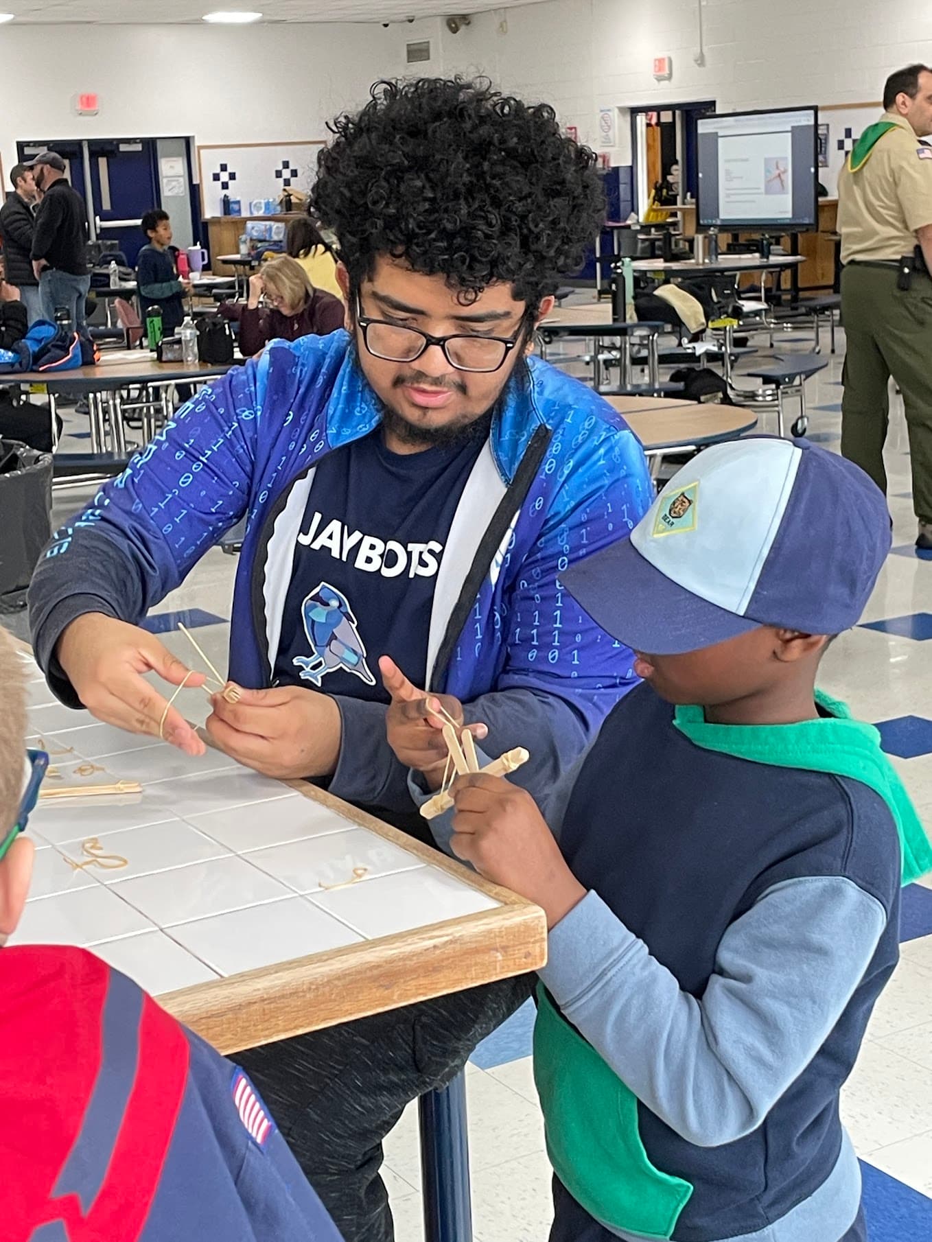 Anthony showing how to make an airplane.