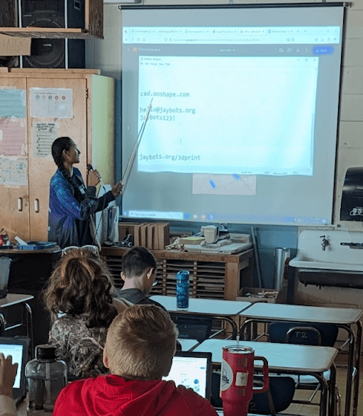 Anika showing students how to CAD